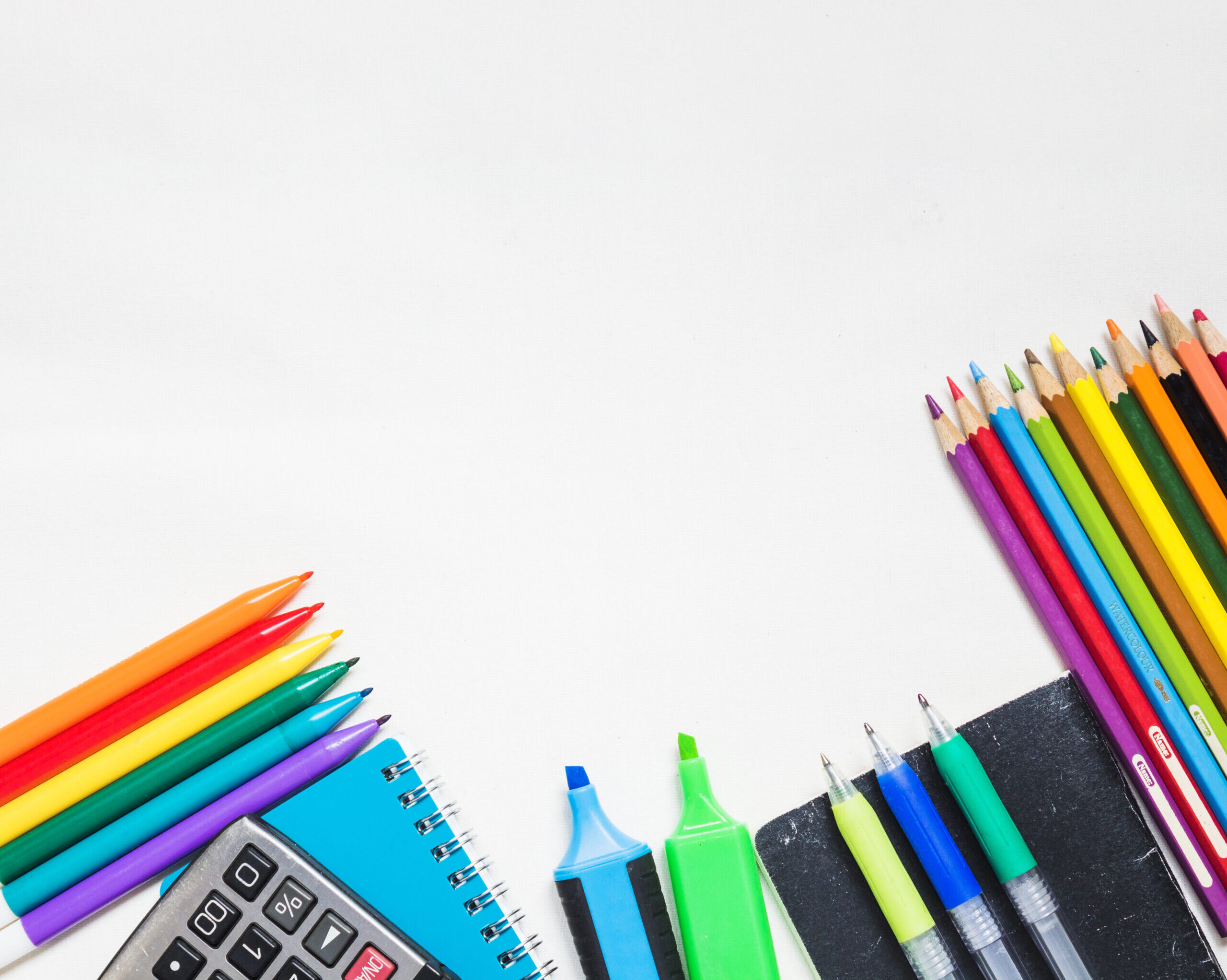 various-drawing-supplies-white-background CARPETAS REGISTRADORES